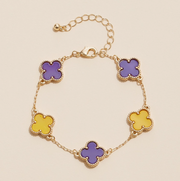 Gold bracelet with purple and yellow clover-shaped enamel charms for game day and LSU sports fans.