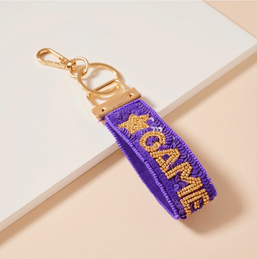 Purple and gold beaded and sequin keychain for game day and LSU sports fans.