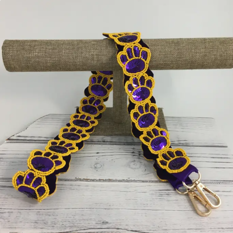 Purple and gold sequin and beaded tiger paw purse strap for game day for LSU sports fans.