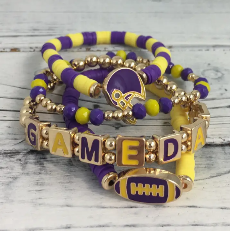 Purple and gold game day beaded bracelet stack featuring a football charms, enamel letter blocks and gold beads for LSU sports fans.