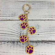 Purple and gold paw print bag or purse charm accessory for gameday and tailgating for LSU sports fans.